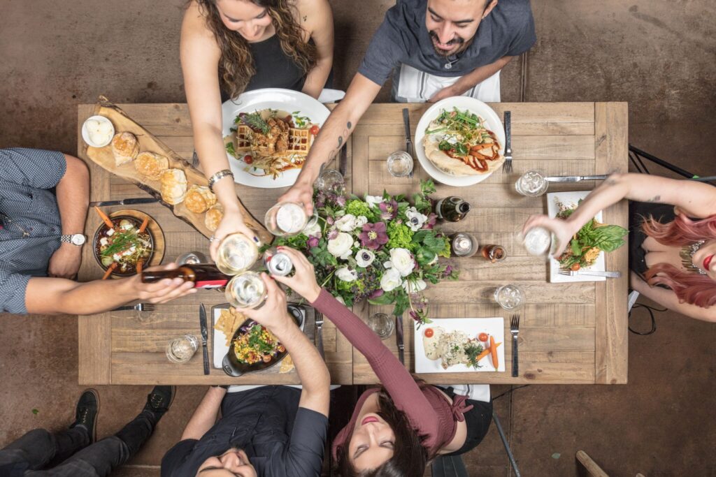 Refreshing Drinks and Cocktails at Hash House A Go Go Orlando 1 Group enjoying farm-fresh dining and drinks at Hash House A Go Go Orlando — where comfort food and celebration meet