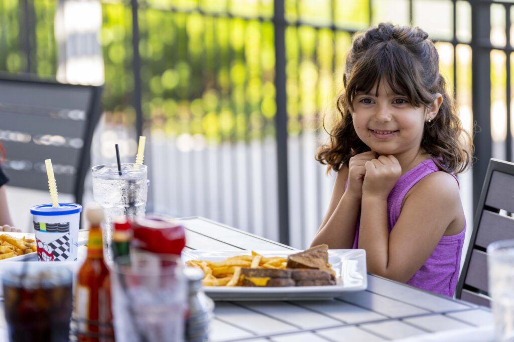 Why Hash House A Go Go Orlando is the Ultimate Brunch Spot for Families and Foodies 1 Young guest enjoying a twisted family lunch at Hash House A Go Go Orlando — a top spot for lunch in Orlando Florida