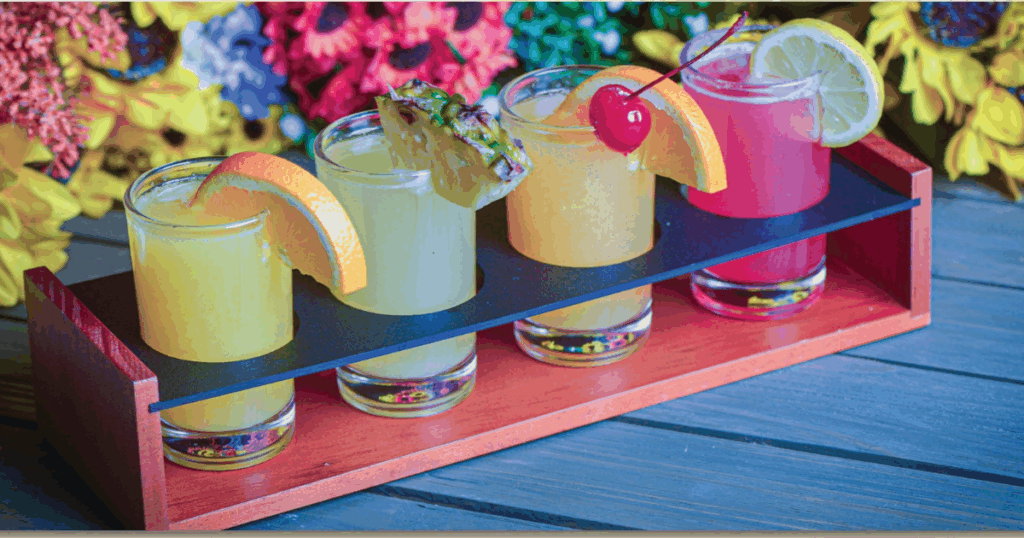 Summer Sips and Twisted Eats: The Limited-Time Menu Orlando Is Talking About 1 Colorful mimosa flight featuring guava, pineapple, strawberry lemonade, and orange juice at Hash House A Go Go Orlando summer limited time menu