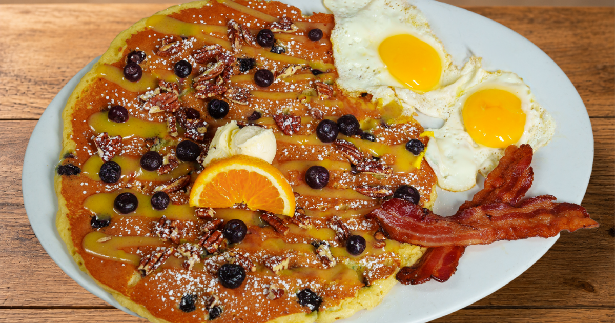 Blueberry Pecan & Lemon Glaze Flapjack with blueberries, candied pecans, eggs and bacon at Hash House A Go Go Orlando